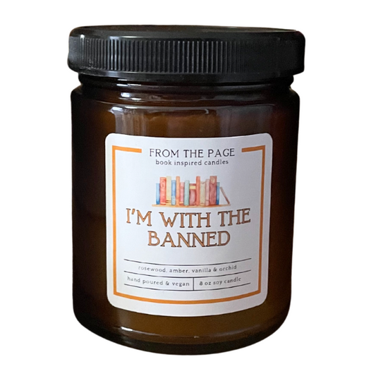 Brown candle jar with a label reading 'I'm with the Banned' on a white background